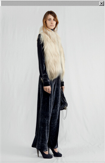 Goat waistcoat worn with a velvet jersey jumpsuit with skirt-pants bottom, a velvet bag and suede pumps.