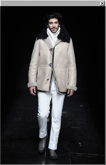 Coated sheepskin coat worn with cotton jeans, a V-neck knitted sweater a knitted scarf and leather low boots with rubber sole.