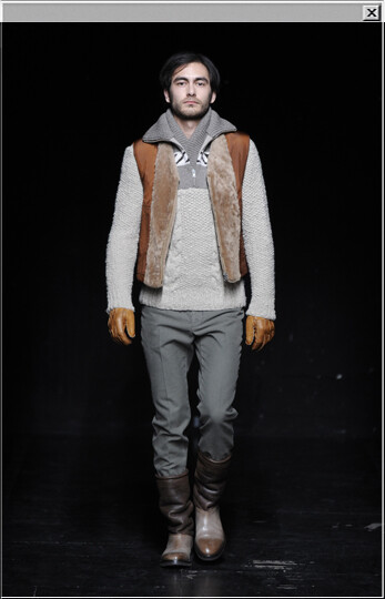 Two-tone wool sweater worn with a Replica sheepskin and nylon waistcoat, cotton pants, a wool and mohair scarf, leather gloves and sheepskin and leather boots.