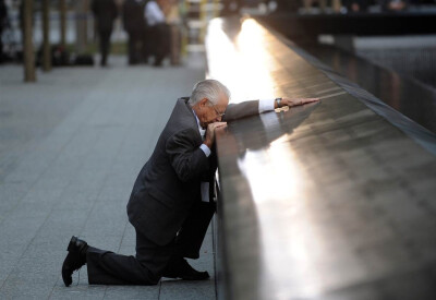 Robert Peraza, who lost his son Robert David Peraza in 9/11, pauses at his son’s name at the North Pool of the 9/11 Memorial.(Getty Images / Justin Lane)