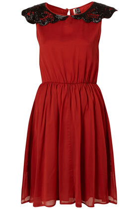 Red dress with beaded collar and ruched waist. 100% Viscose.