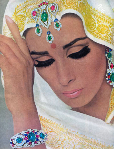 Cartier jewelryModel Wilhelmina with clothing and makeup "Indiana" and using the Cartier jewelry.French Vogue,August 1965.