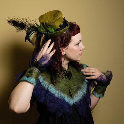 Hand Felted Steampunk Ensembleby ~DreadfulEweHand felted wool capelet, wrist cuffs andmini top hat. All hand dyed. Hat is hand fulled and blocked. Cobweb trim on cuff and capelet are actually very she…