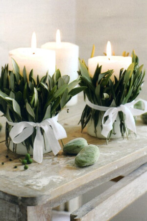 (via Holidays / fresh leaves tied with ribbon candles)