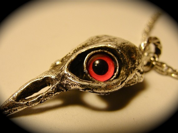 red eyed bird skull silver plated on a nice chai