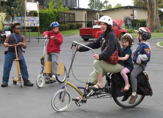 You can build a bike out of a commercially available bike extension cargo rack. Normally this cargo rack mounts behind a standard bike to extent the back wheel 1.5 feet back and makes room for its own large panniers, it has a a wood deck on top and plenty of tie down points for heavy duty hauling.