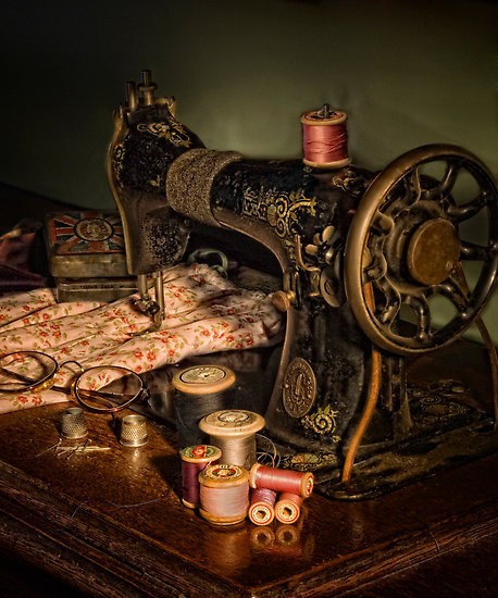 antique sewing machine, fabric, thread, & glasses.... these sewing machines were not electric... they ran by pumping a foot petal underneath..