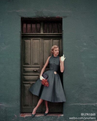 Model wearing a two-piece slate blue dress by Heatherlane, 1955.