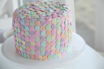 vanilla cake with whipped raspberry bean frosting and pastel sprinkles.