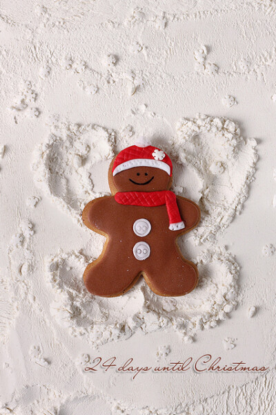 Gingerbread man is making a snow angel