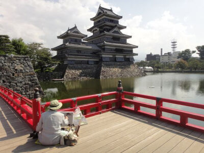 Photo: Artist creating a watercolour of the view of Matsumoto Castle