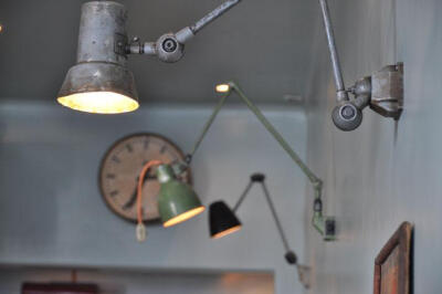 A trio of wall-mounted industrial lights in the Atelier Mecanic in Romania, designed by Corvin Cristian, via Yatzer.