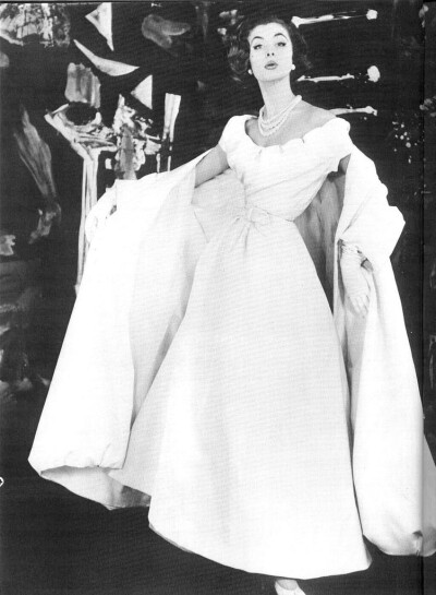 Suzy Parker wearing Dior's white evening gown with matching shawl, 1954