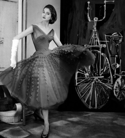 Suzy Parker wearing chiffon dress with pleated skirt with giant rickrack by Jean Desses, 1954