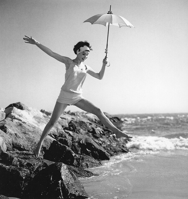 Sondra Peterson in one-piece bathing suit designed by Elisabeth Stewart to look like knit shorts and top, photo by Herman Landshoff, Canary Islands, Mademoiselle 1958