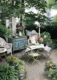 Metal, Wicker and Wood pieces develop a crack-and-peel texture as they weather. An old bureau becomes a buffet; seating comes from a mix of secondhand chairs.