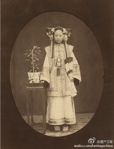 满族妇女。英国摄影师威廉· 桑德斯（William Saunders）摄，1863-1888年间在上海开设“森泰”照相馆。他以肖像见长，关注中国社会各阶层人物，贩夫走卒到清廷高官都是其拍摄对象，刊于《远东》(The Far East)、《伦敦新闻画报》(Illustrated London News)等杂志上，是“中国最早的插图摄影师”。