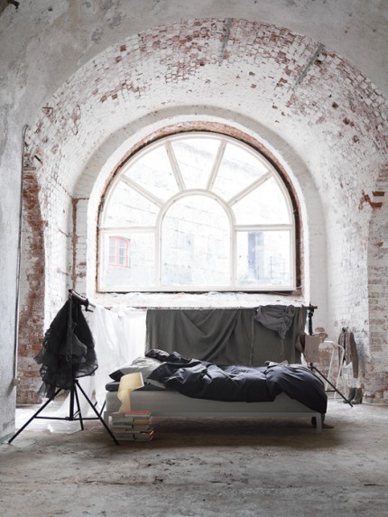 Bedroom interior with exposed brick window