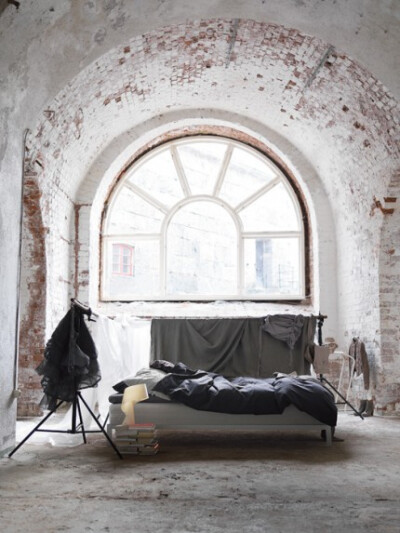 Bedroom interior with exposed brick window