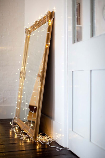 mirror with string lights, from Emma Jane Noren's London apartment, via Design Sponge