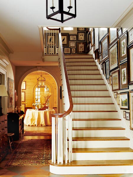 The redesigned front vestibule of this home now functions as a gallery space for the owner's collection of prints and antique maps. The arched entryway frames the new solarium.