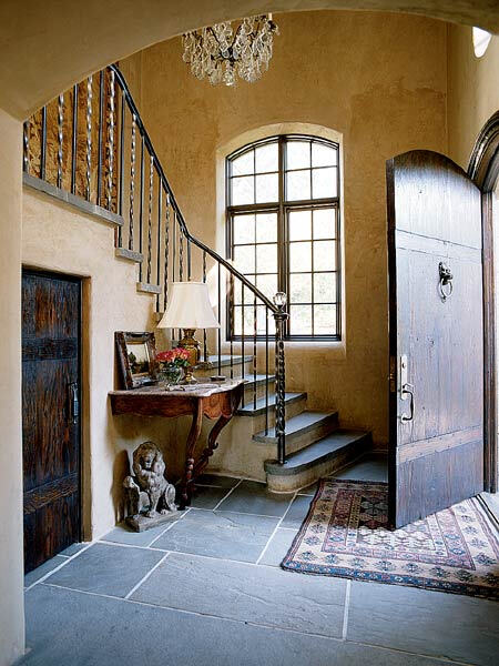 The door of this entry is made of thick planks with mortise-and-tenon joinery to reflect the solid, handcrafted feel of the house. To reinforce the impression of solid masonry, the interior walls were plastered and thickened.