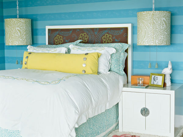 Oversize drum shades help to balance the linear walls, headboard, and nightstands in this Laguna Beach bedroom. The bright striped wallpaper look can be achieved with paint by choosing vibrant colors in at least 4-inch-wide stripes.