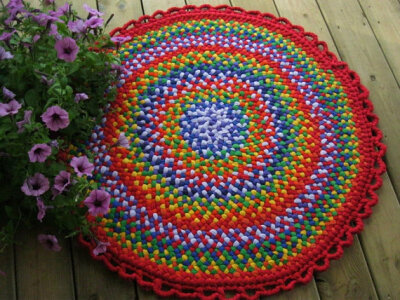 This handmade braided rug has much color and energy! It measures 34" without the border. It was designed and made by me using all clean upcycled cotton and upholstry fabrics. The round rug is reversib…