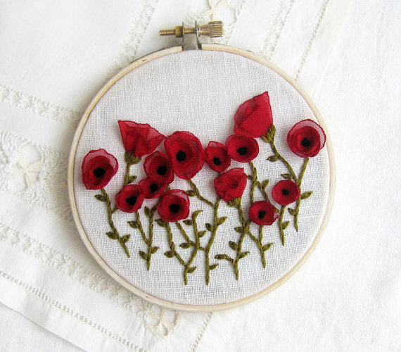 http://www.etsy.com/listing/92698724/hand-embroidered-red-poppies-wall-decor