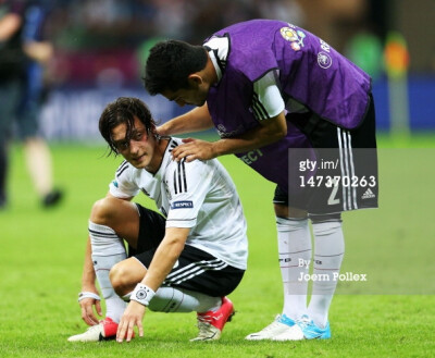 News Photo: Mesut Ozil of Germany is comforted by his…