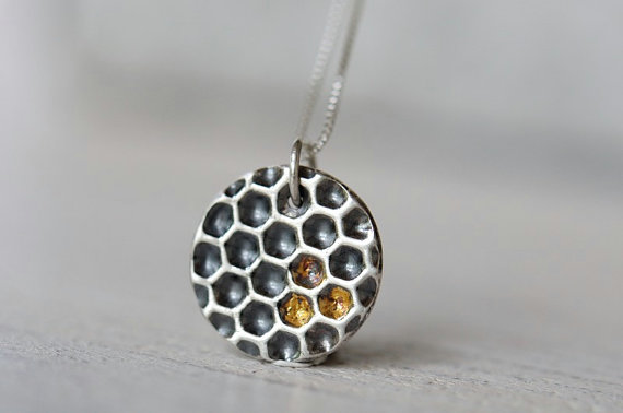 Silver honeycomb necklace with gold honey details.