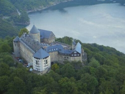 Burg Eltz castle Burg Eltz is a medieval castle nestled in the hills above the Moselle River between Koblenz and Trier, Germany. It is still owned by a branch of the same family that lived there in the 12th century, 33 generations ago.