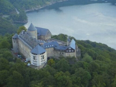 Burg Eltz castle Burg Eltz is a medieval castle nestled in the hills above the Moselle River between Koblenz and Trier, Germany. It is still owned by a branch of the same family that lived there in t…