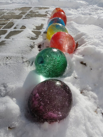 Fill balloons with water and add food coloring, once frozen cut the balloons off and; they look like giant marbles.