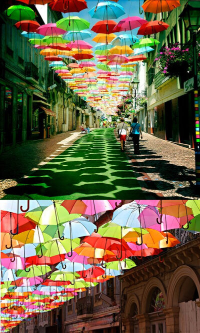 葡萄牙小镇 Águeda 利用大量的雨伞装置他们的街道，雨伞不只替路人遮挡了艳阳，更让整条街充满缤纷的色彩！