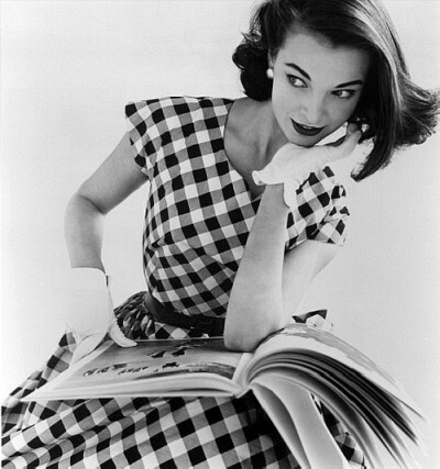 Model Helen Bunney in a black and white checked dress, London, 1957. Photo by John French.