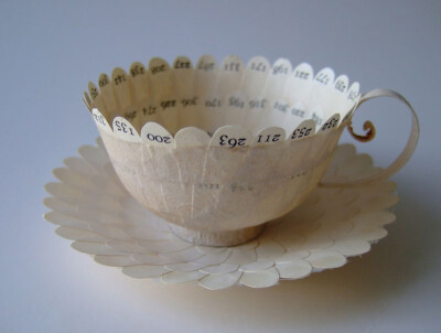 paper cup made of cut up book pages and glue