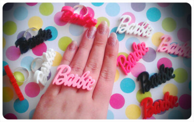 Barbie Logo Ring On Adjustable Band. Comes in Baby Pink, Hot Pink, White, Red Or Black. Very cute.