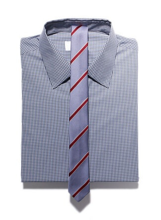 Cotton check shirt, $580, by Prada; silk stripe tie, $80, by Saint Augustine Academy.