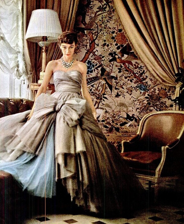 In the sun room of Dior's house in Passy, Sophie Malgat wears the newest of Dior's "big" ball gowns, the skirt has 12 layers and is separate from the bodice because of its weight, photo by Mark Shaw, 1953