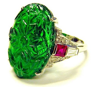 Carved emerald ring with rubies and diamond in platinum