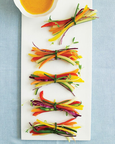 Small slivers of vegetables tied with edible chive ribbons with a tangy carrot-ginger dipping sauce.