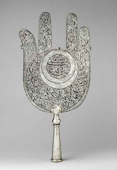 Standard in the shape of a palm, early 18th century Iran Silver with black inlay H. 19 1/4 in. (48.9 cm), W. 9 in. (22.9 cm) Gift of Dr. Marilyn Jenkins, 1984 (1984.504.2)