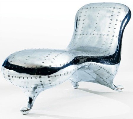 The Lockheed Lounge designed by Marc Newson is a one person lounge. It shows obviously marks where material were joint, enhancing the &#39;post-industrial&#39; style. As well as being post industrial, this product is ergonomic considering the curves in the design.