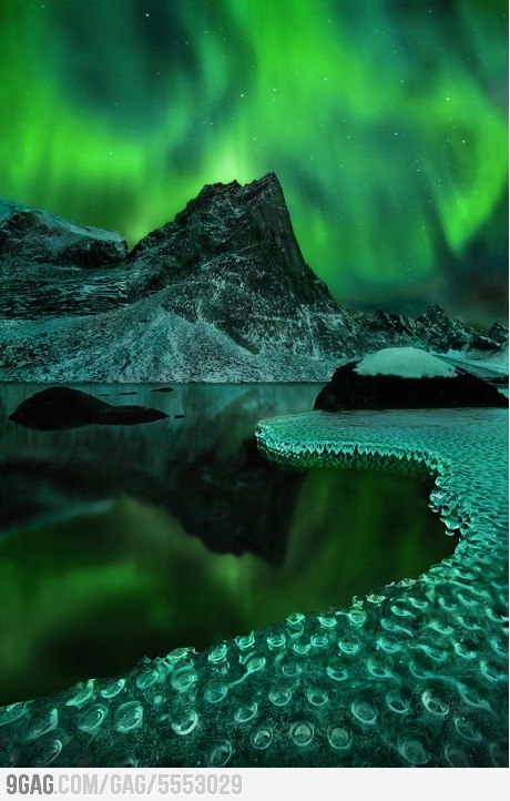 Magical view of Aurora Borealis reflected on frozen icicles.