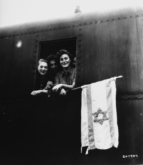 Jewish children holding the Israeli flag while hanging out of a train window after having been released from Buchenwald Concentration Camp, on their way to Palestine at the end of World War II. Photograph by James E. Myers. Germany, June 1945. Repinned from history.in.the.making by Tina Kol