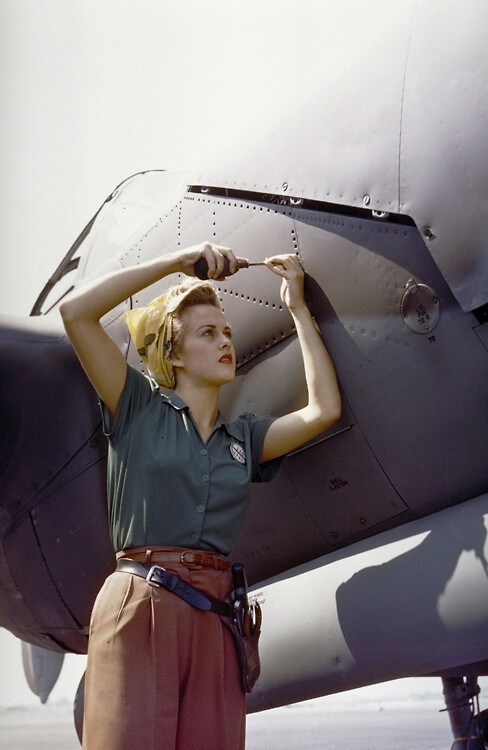 A female Lockheed employee works on a P-38. Lighting Burbank, CA  1944