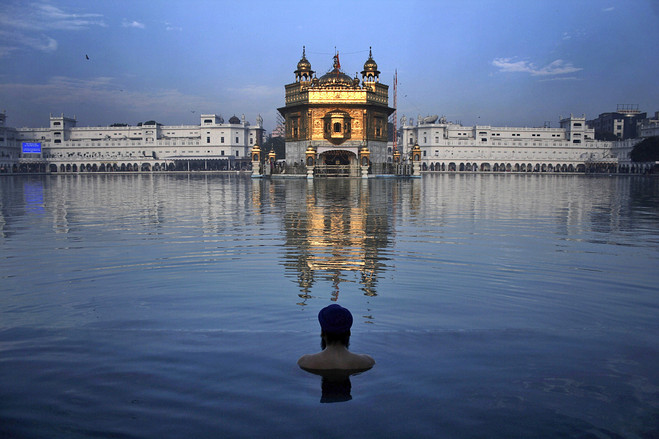 HOLY BATH: An Indian Sikh devotee took a dip in the sacred pond of the Golden Temple, in Amritsar, India, during celebrations of the anniversary of the birth of Guru Nanak, the founder of Sikhism.