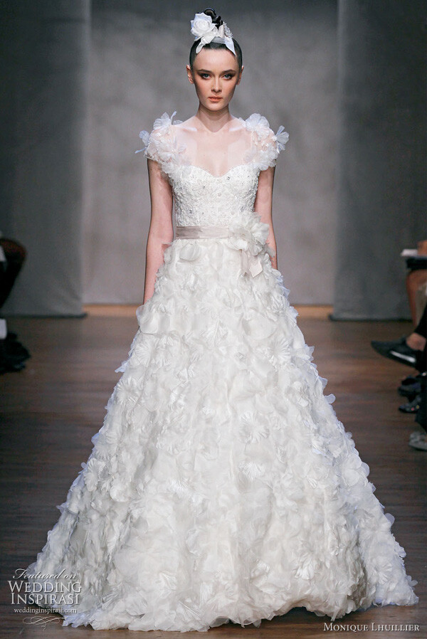 Monique Lhuillier Fall 2011 wedding dress : Dandelion - silk white embellished chantilly lace bodice with floral embroidered organza A-line skirt and embellished illusion sleeves, cameo hyacinth belt, silk white dandelion brooch