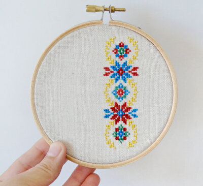 Ukrainian ornament hand embroidery cross stitch in wooden hoop